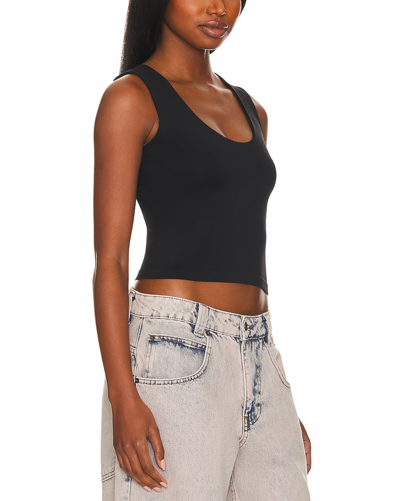 Free People Clean Lines Muscle Cami Black. A new addition to your favorite seamless collection. This sleek tank is featured in a buttery soft fabrication with a scoop-neckline and sleeveless silhouette is a must have basic.