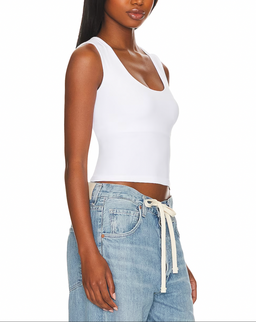 Free People Clean Lines Muscle Cami White. A new addition to your favorite seamless collection. This sleek tank is featured in a buttery soft fabrication with a scoop-neckline and sleeveless silhouette is a must have basic.