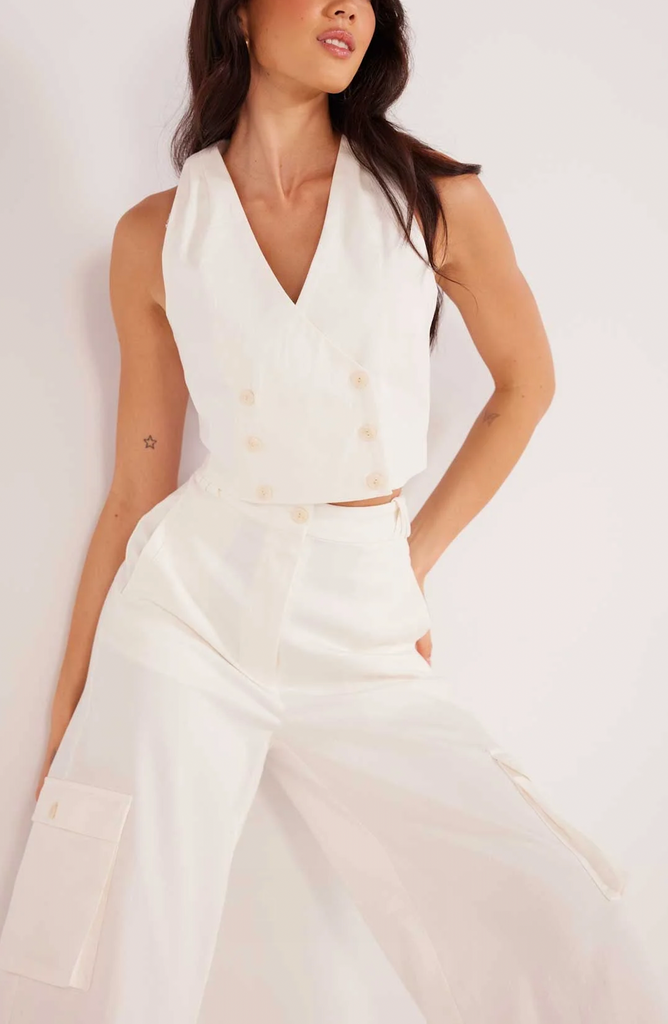 Lottie Halter Vest White. This cropped halter vest features a double breasted button down design and goes perfectly with the Lottie Cargo Pants as an adorable set.