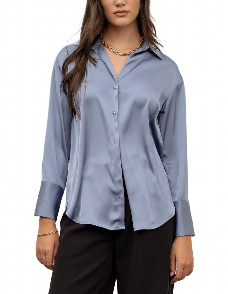 Beautiful Chaos Satin Button Up Blouse Dusty Blue. This satin blouse features a long sleeve collared button up design that can be worn closed on its own or open over a fitted top, the perfect chic piece to wear any day.