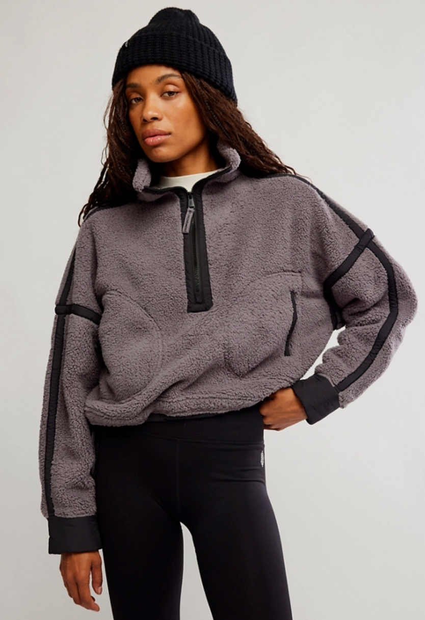 Soft fleece with a warm feel; durable top-applied nylon seams; zipped front pockets; high-neckline with half-zip closure; drop-shoulder sleeves; drawcord at bottom hem for adjustability; thick contrast cuffs. Fleece jacket