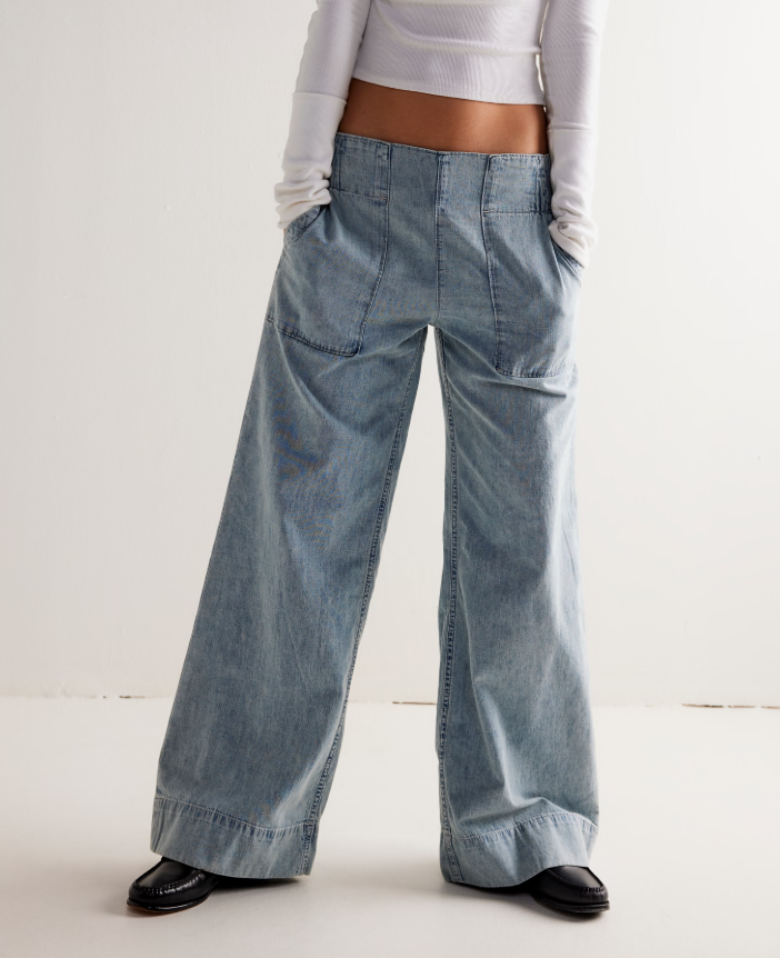 Model wearing relaxed wide leg jeans with oversized front patch pockets.