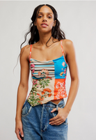 Patchwork cami top featuring floral and stripe prints with adjustable spaghetti straps and open tie-back detail.
