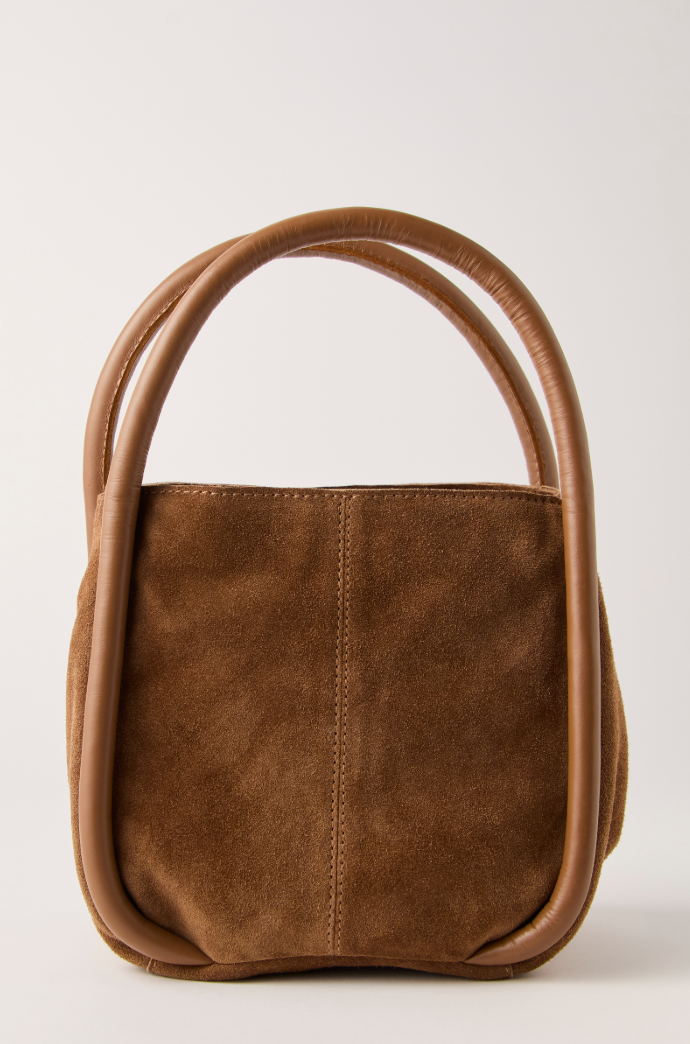 Suede tote bag with rounded top handles and structured silhouette.