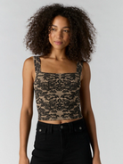 Women’s fitted cropped lace top with a square neckline and wide shoulder straps.