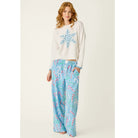 Ivory crewneck sweater with blue snowflake graphic, dropped shoulders, and contrasting blue cuffs