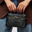 Urban Expressions Snow Crossbody Bag in Black, held by the top handle