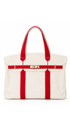 Structured canvas tote bag with contrast handles, decorative buckle detail, gold-tone hardware, and a spacious carryall design.