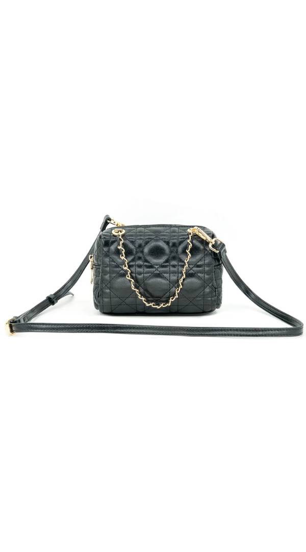 A black quilted leather shoulder bag with a gold chain strap and a long black leather shoulder strap, displayed against a solid white background.