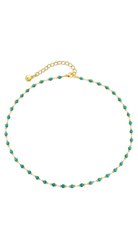 Delicate gold beaded necklace with turquoise-inspired stones and adjustable chain closure on a light background.