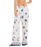 Printed wide leg pants with beach-inspired graphics and drawstring waist, styled for a relaxed summer look