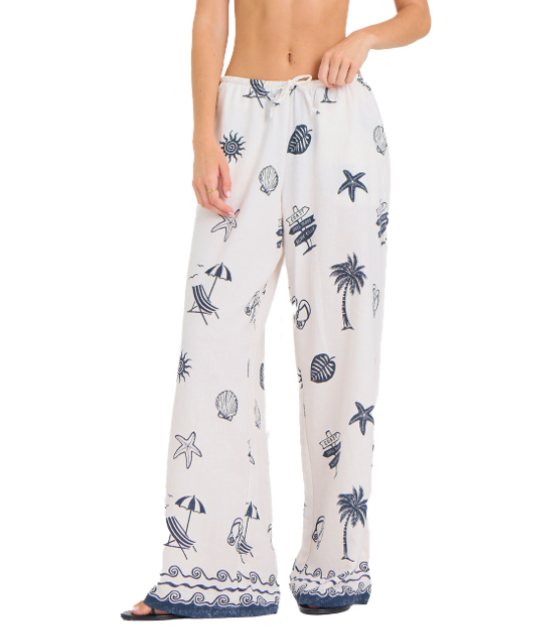 Printed wide leg pants with beach-inspired graphics and drawstring waist, styled for a relaxed summer look