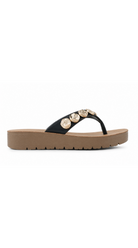 Platform flip flop sandal with embellished strap and cushioned sole.