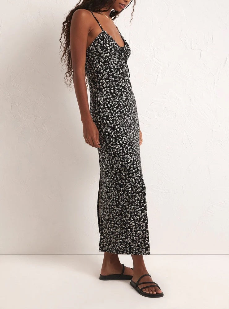 Z Supply Melinda Gia Ditsy Mini Dress Floral Black Pattern. Flattering and fun, you'll live in the Melinda Gia Ditsy Midi Dress all season! The flattering neckline and body skimming fit are perfect for a day in the sun, but throw on a statement coat and boots or heels and you're ready for a night out.