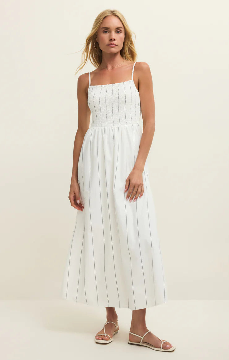 Smocked strap midi dress with fitted bodice and flowy skirt on model