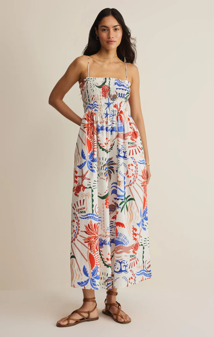 Printed midi dress with thin straps, smocked bodice, and relaxed fit styled with flat sandals
