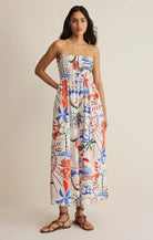 Printed midi dress with thin straps, smocked bodice, and relaxed fit styled with flat sandals

