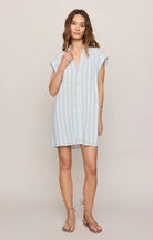 Relaxed button-front shirt dress with cap sleeves and vertical stripe pattern styled with flat sandals