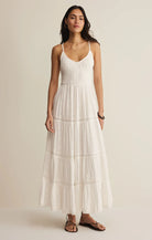 Tiered maxi dress with a smocked bodice, adjustable straps, and a flowing silhouette.