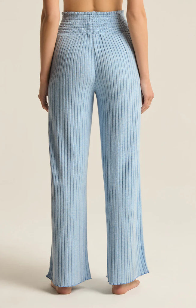 Z Supply Dawn Smocked Rib Pant Blue Jay. This pant gives all the cozy rib feels, made using ultra soft silky rib fabric. The elastic waistband plus the straight style and easy fit make this pant perfect for relaxing all day.