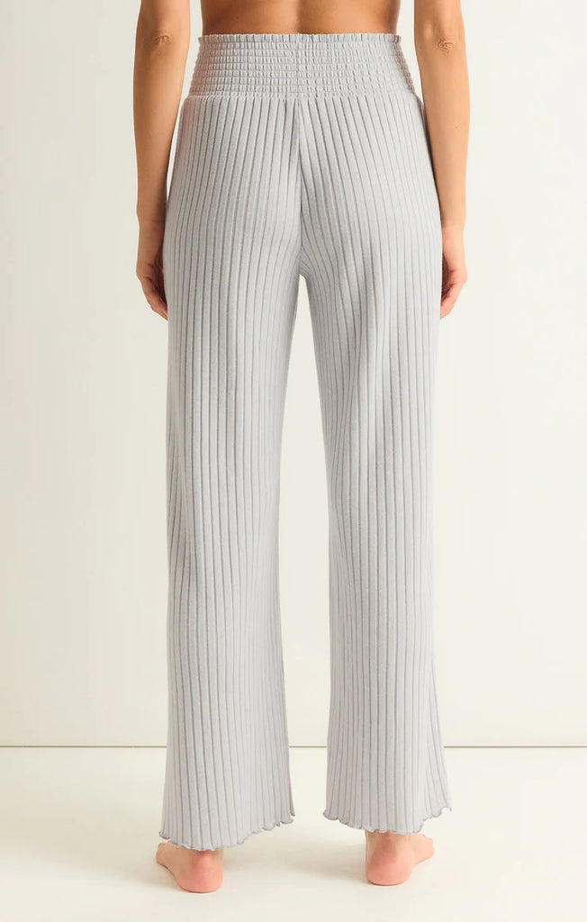 Z Supply Dawn Smocked Rib Pant Platinum Grey. This pant gives all the cozy rib feels, made using ultra soft silky rib fabric. The elastic waistband plus the straight style and easy fit make this pant perfect for relaxing all day.