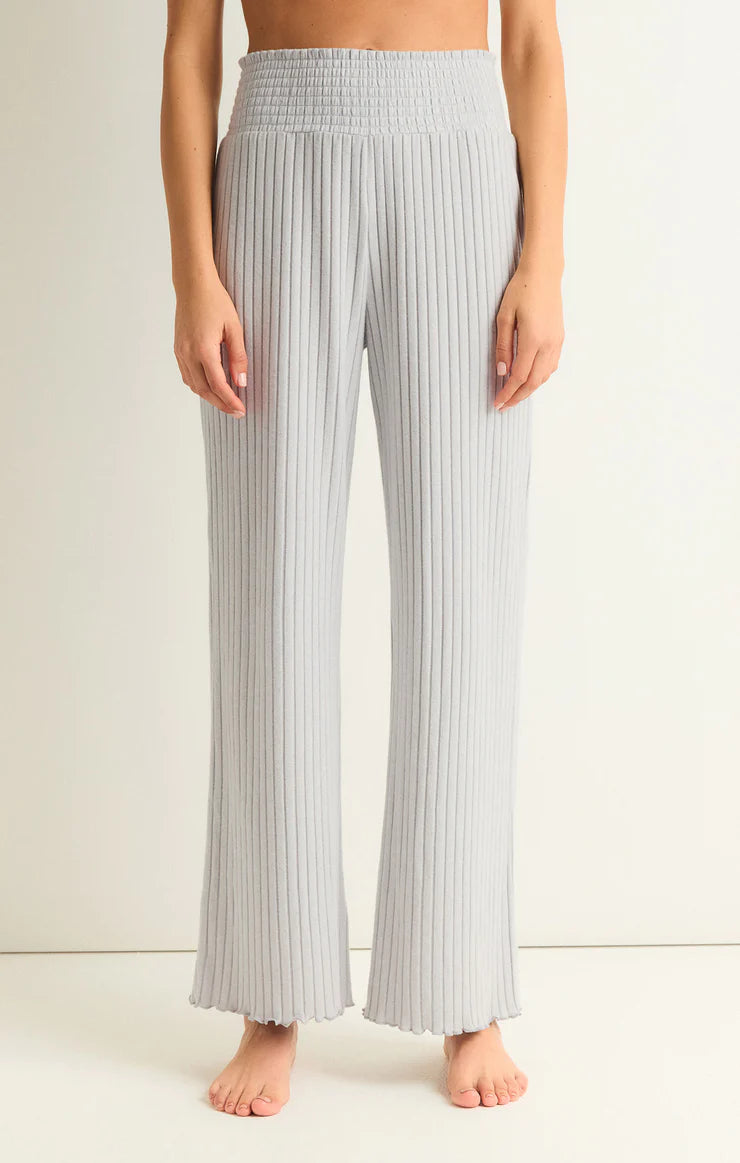Z Supply Dawn Smocked Rib Pant Platinum Grey. This pant gives all the cozy rib feels, made using ultra soft silky rib fabric. The elastic waistband plus the straight style and easy fit make this pant perfect for relaxing all day.
