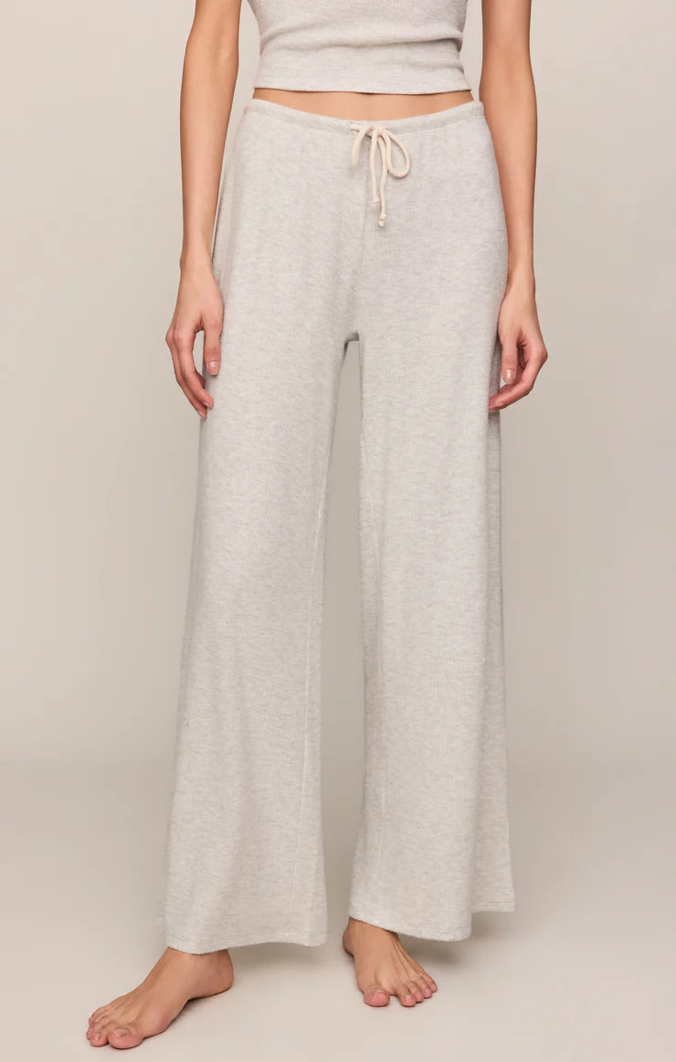Model wearing ultra-soft wide-leg knit lounge pants with a drawstring waistband and relaxed fit paired with a matching knit top.