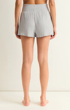 Z Supply Dawn Smocked Rib Short Platinum Grey. The Dawn Smocked Rib Short is a must have, made using a cozy silky rib fabric. The smocking detail is soft and flattering and the lettuce edge gives us all the feels with just the right amount of frills.