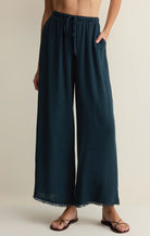 Wide leg linen pants with elastic drawstring waist and relaxed fit styled with flat sandals