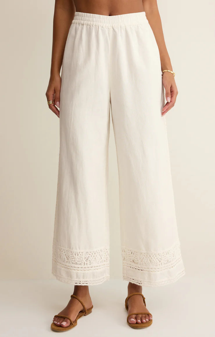 Wide leg pull-on pants with an elastic waistband and crochet trim detail at the hem.
