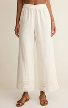 Wide leg pull-on pants with an elastic waistband and crochet trim detail at the hem.
