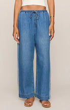 Relaxed wide-leg denim pants with an elastic drawstring waistband and an easy, flowy fit.