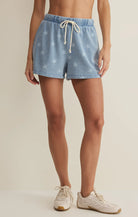 Pull-on shorts with elastic drawstring waist and subtle star print styled with sneakers
