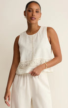 Sleeveless flowy top with crochet trim detailing and a relaxed silhouette.

