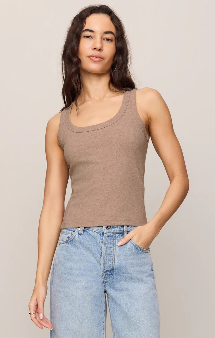 Fitted scoop neck knit tank top with a sleeveless design and soft stretch fabric, styled with relaxed denim jeans.