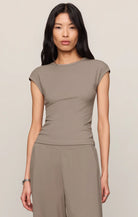 Model wearing a fitted cap sleeve knit tee with a crew neckline styled with relaxed lounge pants.