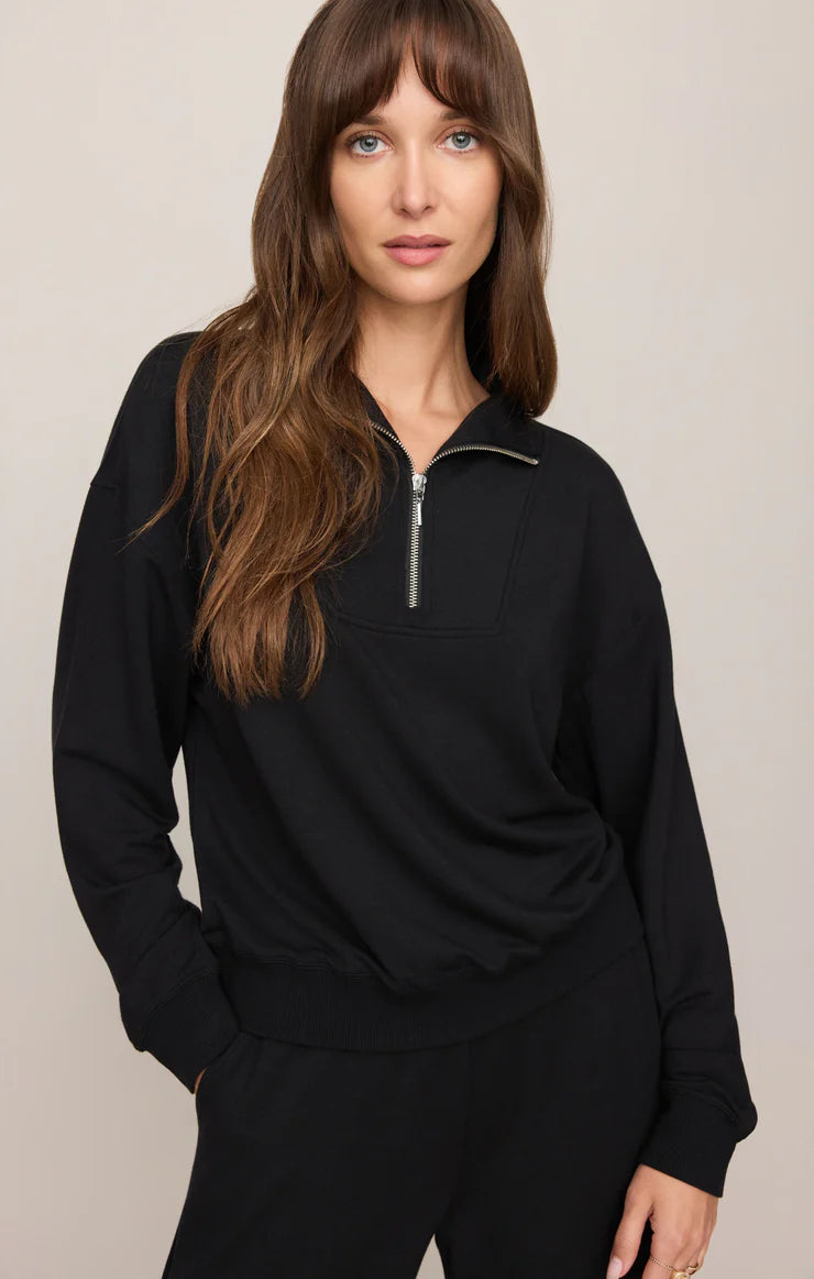 Model wearing a buttery-soft quarter-zip pullover with a relaxed fit and ribbed cuffs paired with matching lounge pants.