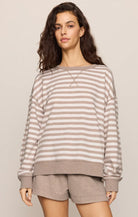 Oversized striped crewneck sweatshirt with long sleeves, ribbed trim, and a relaxed fit, styled with matching lounge shorts.