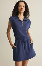 Sleeveless half-zip dress with drawstring waist and relaxed fit styled with hands in pockets