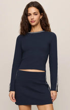 Fitted long-sleeve crewneck top with contrast piping and slit cuffs.