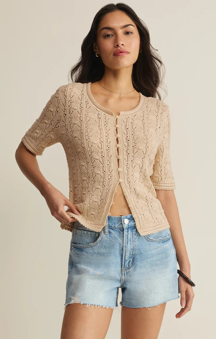 Short sleeve crochet knit cardigan with open-knit detailing and front tie closures.
