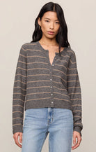 Model wearing a striped button-front knit cardigan with a relaxed fit, styled with light-wash jeans against a neutral studio background.