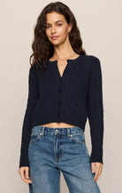Cable-knit button-front cardigan with long sleeves, cropped fit, and ribbed trim.