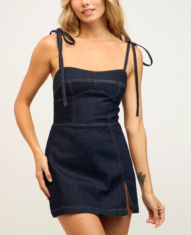 Hazel Denim Mini Dress. This denim mini dress features a sleeveless fit with tie straps and zip back closure, the perfect dress for a cute effortless look day or night.