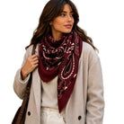 Oversized square scarf with a bandana-inspired print and lightly fringed edges.