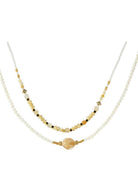 Layered beaded necklace with mixed beads, gold-tone accents, and a natural stone-inspired center bead on a double-strand design.