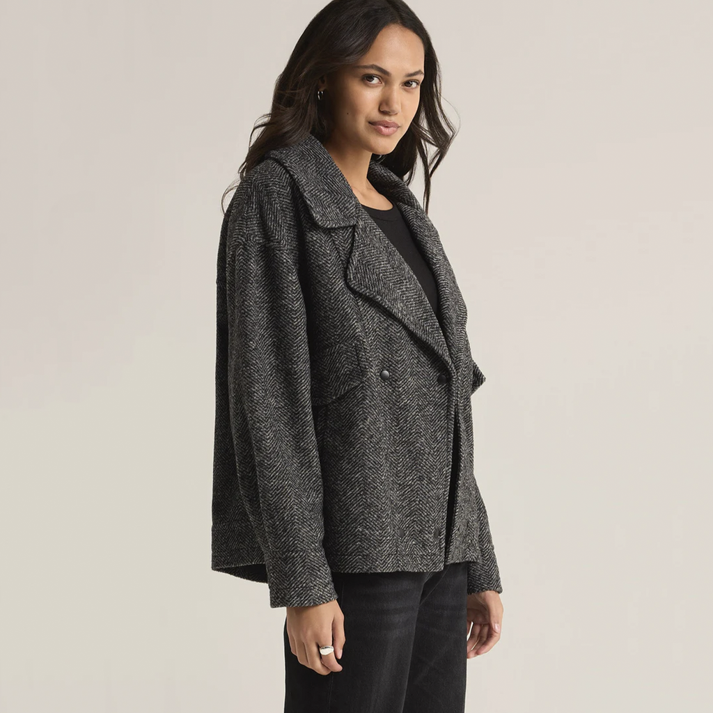 Add a timeless touch to your wardrobe with this Herringbone Bouclé Jacket, designed with a classic collared neckline and button-front closure. The heavyweight fabric keeps you cozy during cooler days, while the flap pockets offer both practicality and a chic finish. Perfect for layering, this jacket combines style and function for a versatile, sophisticated look.