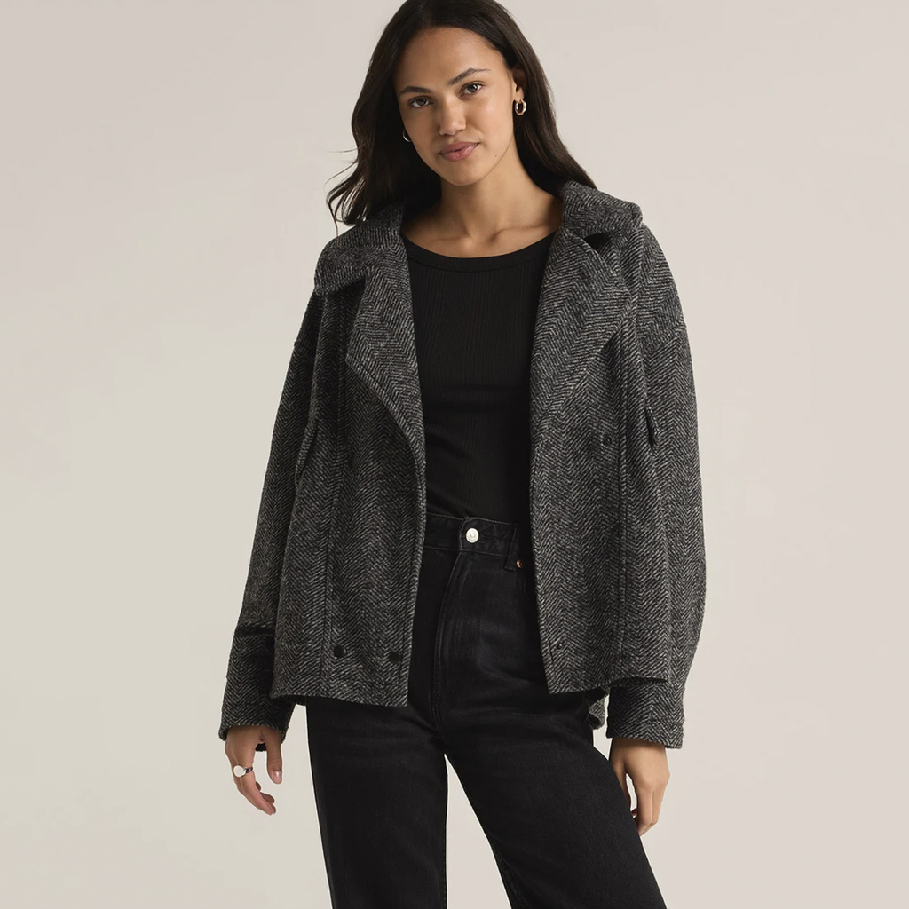 Add a timeless touch to your wardrobe with this Herringbone Bouclé Jacket, designed with a classic collared neckline and button-front closure. The heavyweight fabric keeps you cozy during cooler days, while the flap pockets offer both practicality and a chic finish. Perfect for layering, this jacket combines style and function for a versatile, sophisticated look.