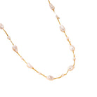 Gold-tone chain necklace featuring irregular pearl-inspired accents spaced throughout a delicate strand, creating an elegant and organic look.