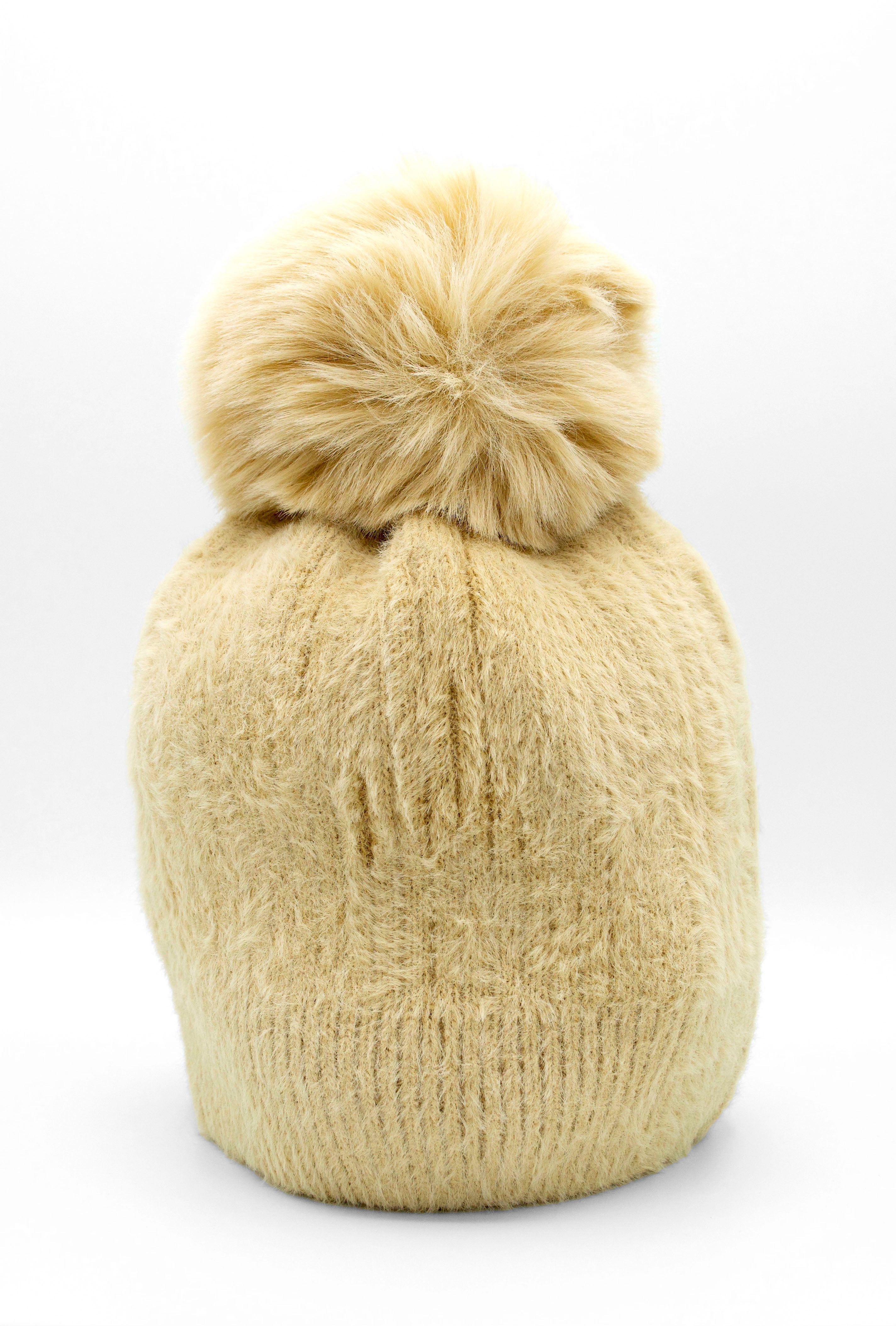 Classic Fuzzy Pom Beanie Beige. This fuzzy beanie features a soft fuzzy fabric with a pom-pom on top, perfect for wearing everyday in the colder months.